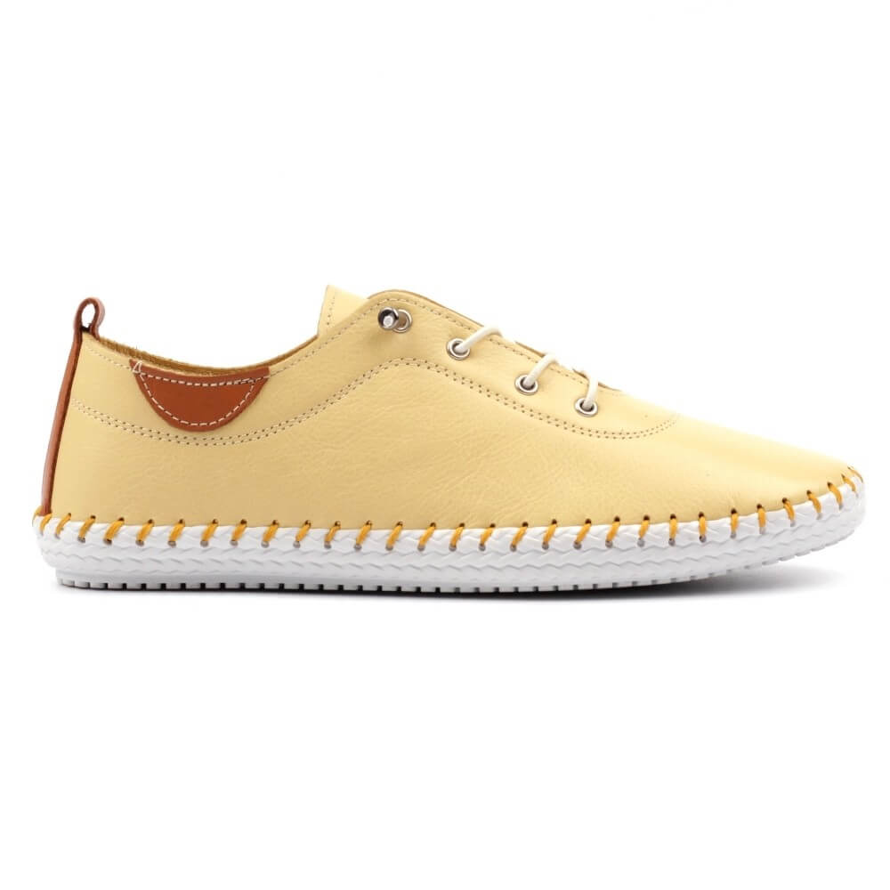 Yellow sneaker with white sole on a white background
