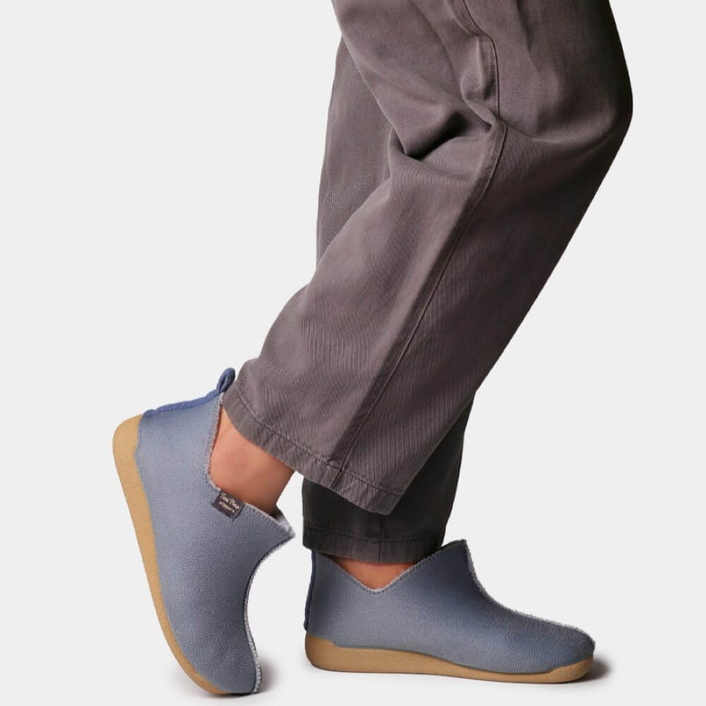 Person wearing blue slippers